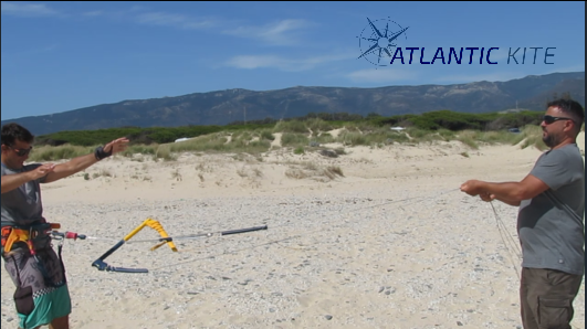 flying a kitesurf in sand